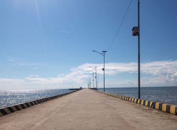 Street by sea against sky