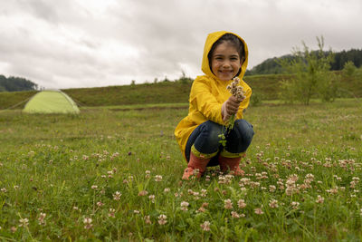 Full length of smiling girl on field