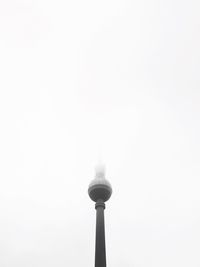 Low angle view of communications tower against sky