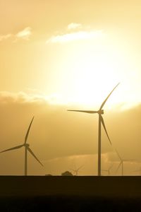 Silhouette of windmill against sky during sunset