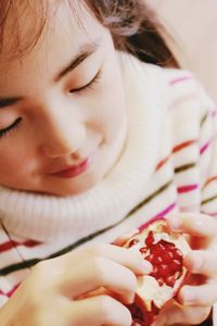 Close-up of girl holding pomegranate