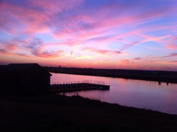 Scenic view of calm lake at sunset