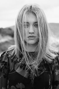 Close-up portrait of young woman standing outdoors