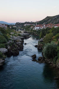 River amidst rocks against clear sky