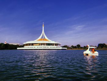 Boat in river with buildings in background