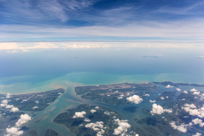 Aerial view of sea and mountains against sky