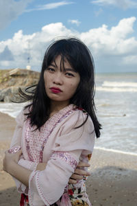 Portrait of woman standing on beach