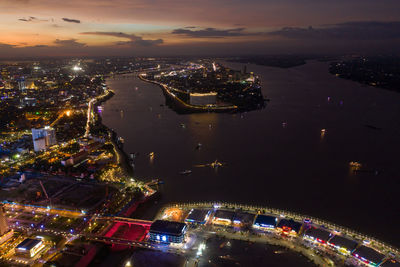 High angle view of city lit up at night