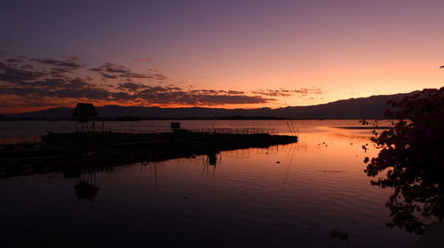 Scenic view of lake against sky during sunset