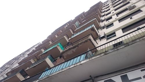 Low angle view of office building against clear sky