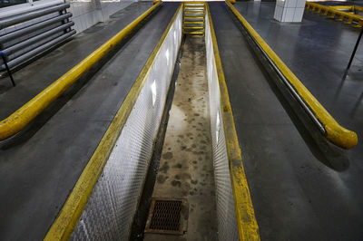 High angle view of yellow tracks on road