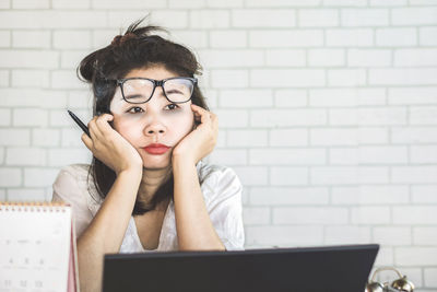 Portrait of young woman using mobile phone