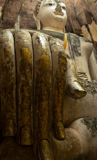 Close-up of buddha statue in temple outside building