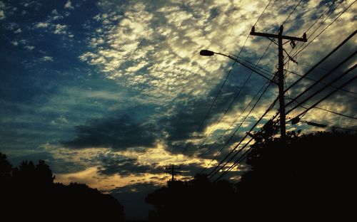 Low angle view of silhouette trees against sky at sunset