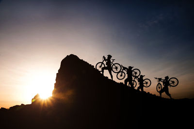 Low angle view of silhouette man standing against clear sky during sunset