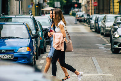 Woman walking on street in city