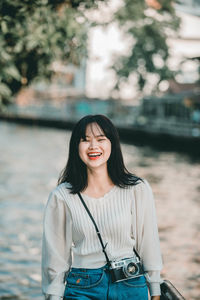 Portrait of a smiling young woman standing outdoors