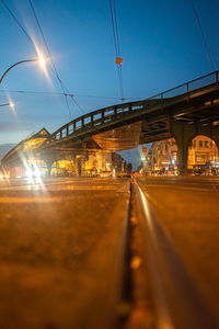 Illuminated railroad tracks against sky