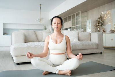 Pregnant woman meditating at home