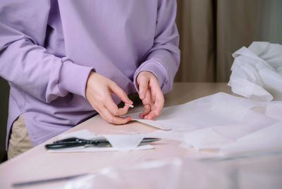 Midsection of man working on table