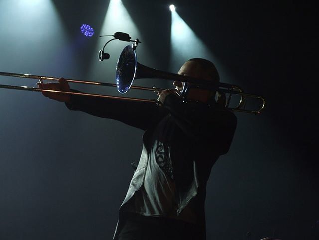 low angle view, lighting equipment, silhouette, street light, electricity, illuminated, technology, music, performance, one person, blue, indoors, musical instrument, skill, flying, arts culture and entertainment, night, cable