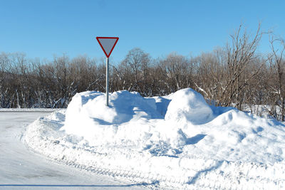 Snow covered landscape against sky