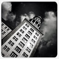 Low angle view of building against cloudy sky