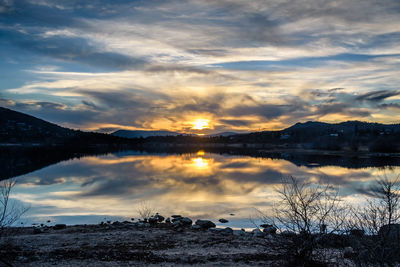 Scenic view of lake against sky during sunset