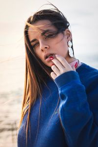 Portrait of beautiful young woman holding camera