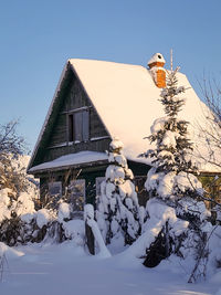 House on snow covered landscape