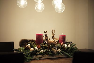 Close-up of illuminated christmas decoration on table at home