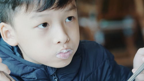 Close-up of cute boy eating food