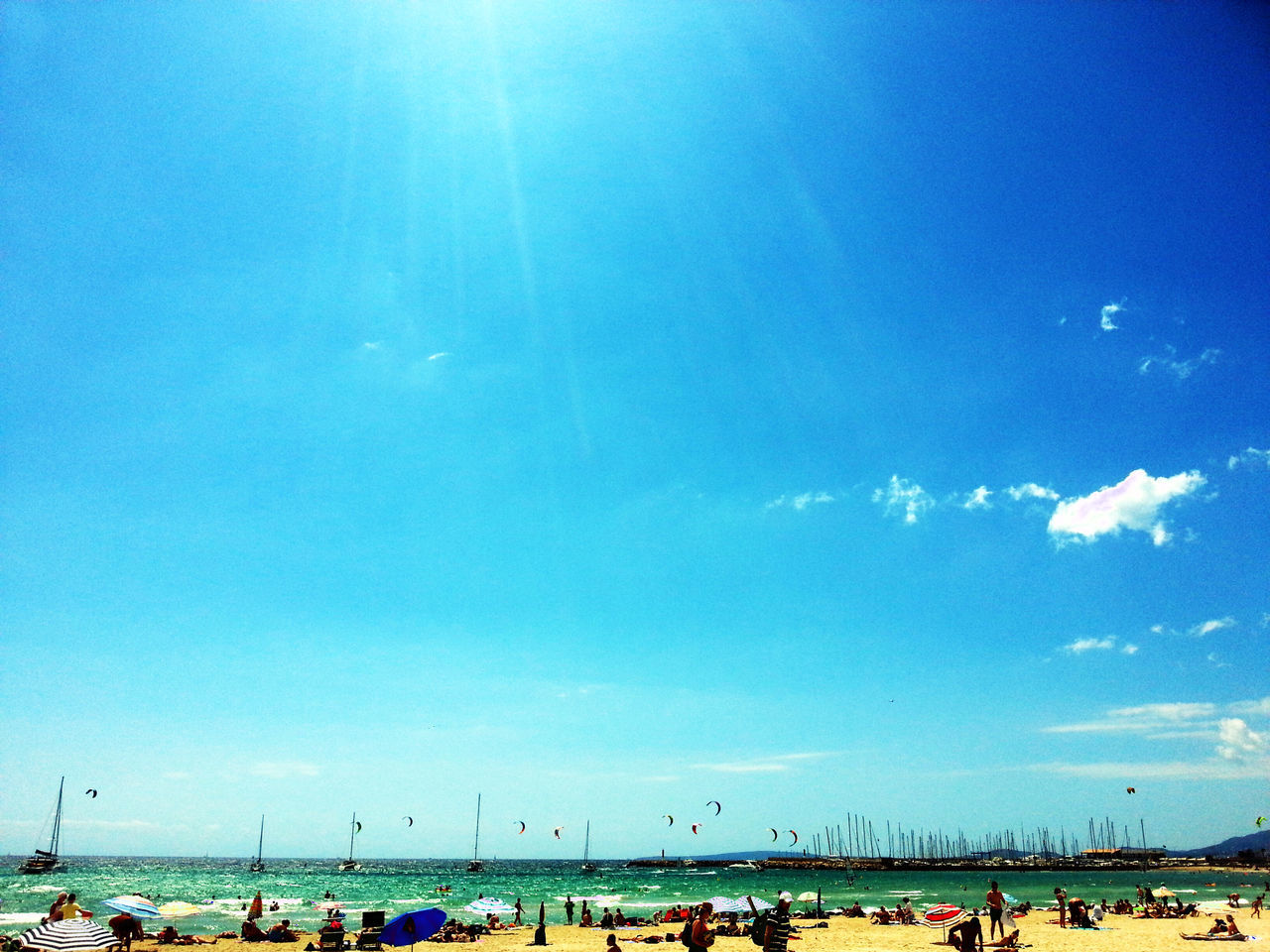 large group of people, sea, beach, blue, water, mixed age range, horizon over water, sky, leisure activity, vacations, enjoyment, shore, lifestyles, tourist, person, enjoying, men, nature, scenics