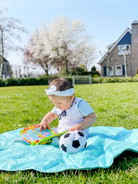Boy playing with ball on field