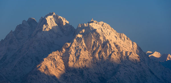 Scenic view of rocky mountains against clear sky during winter