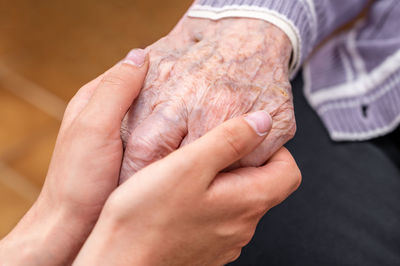 Cropped hand of person holding hands