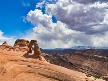 Scenic view of delicate arch against cloudy sky