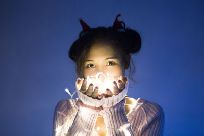 Close-up of young woman against clear sky