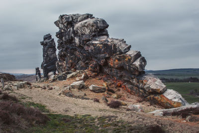 Rock formation on land against sky