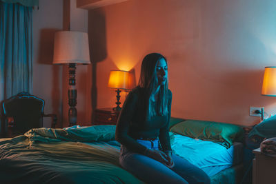 Woman relaxing on bed at home