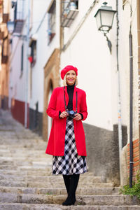 Portrait of young woman standing on street