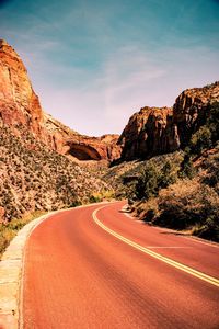 Road amidst mountains against sky