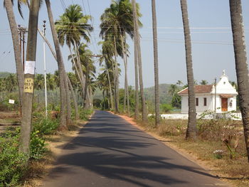 Road amidst trees against sky