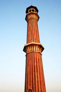 Low angle view of historic column against clear blue sky