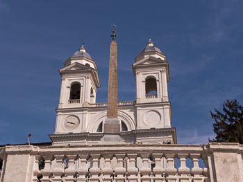 Low angle view of bell tower against blue sky