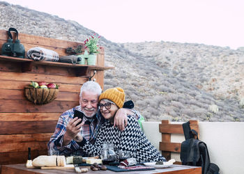 Happy friends sitting on top of woman