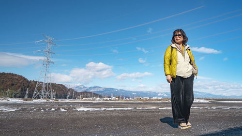 Portrait of young woman standing on snow