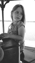 Portrait of a girl sitting by water