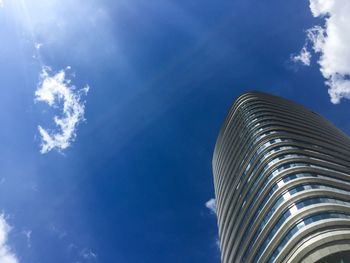 Low angle view of modern building against blue sky