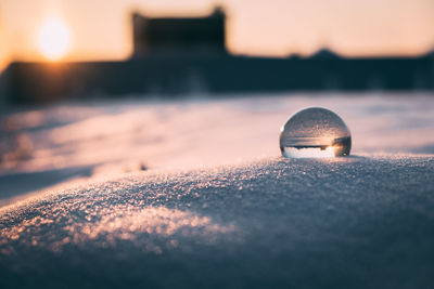 Surface level of ball on beach against sky during sunset